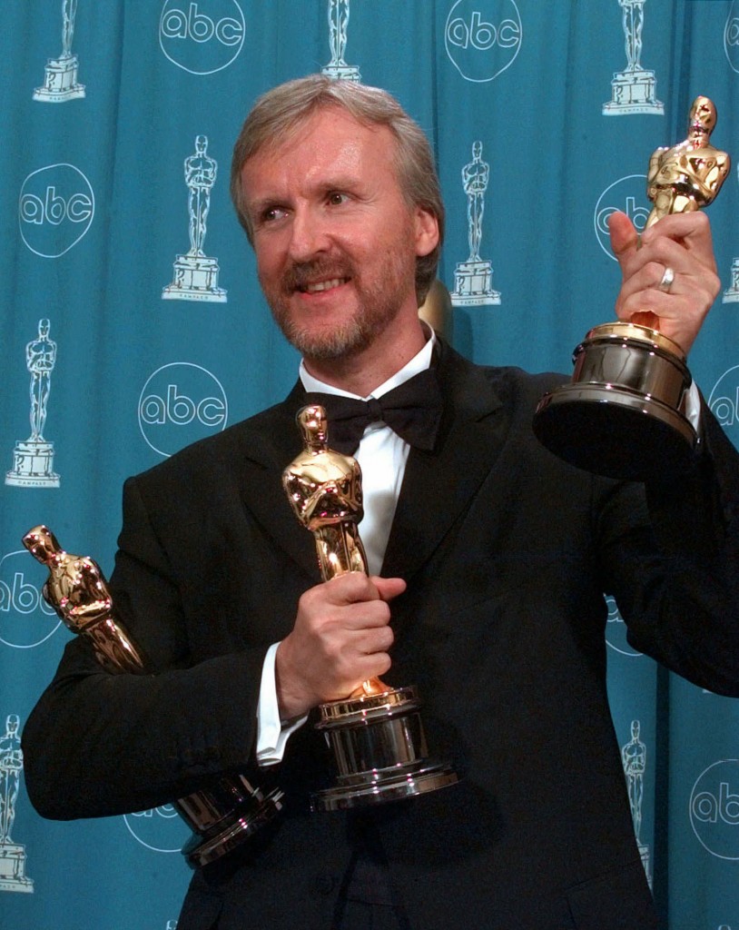 James Cameron holds his three Oscars for the film "Titanic" at the Shrine Auditorium in Los Angeles, Monday, March 23, 1998.  Cameron won the three awards for Best Director, Best Picture and Best Film Editing. (AP Photo/Reed Saxon)